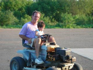 baby riding the mower